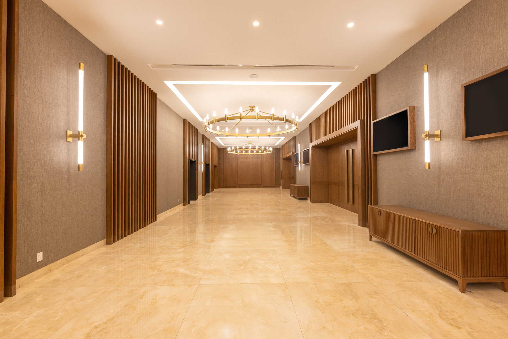 a large room with a chandelier and a television