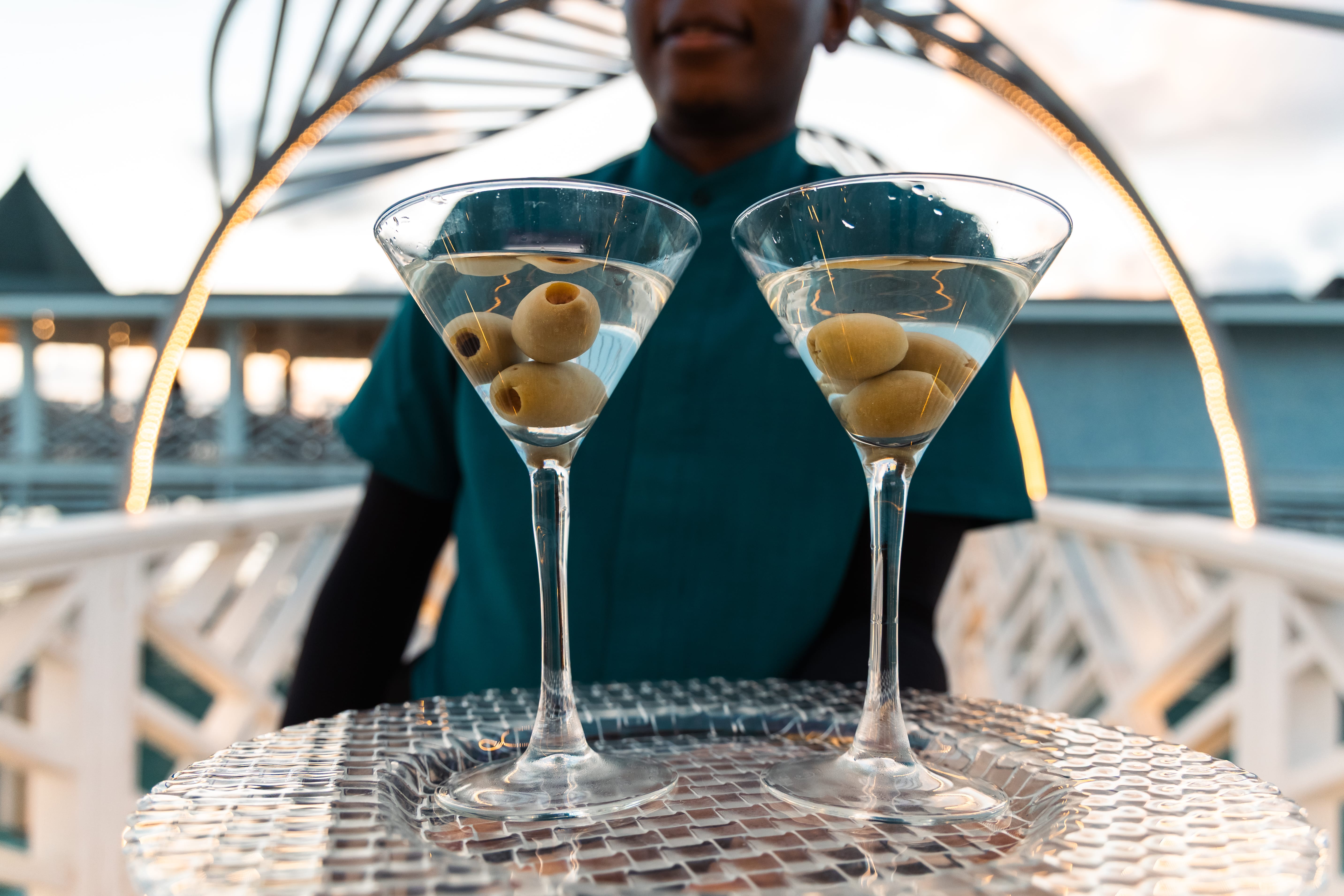 a couple of martini glasses with olives in them