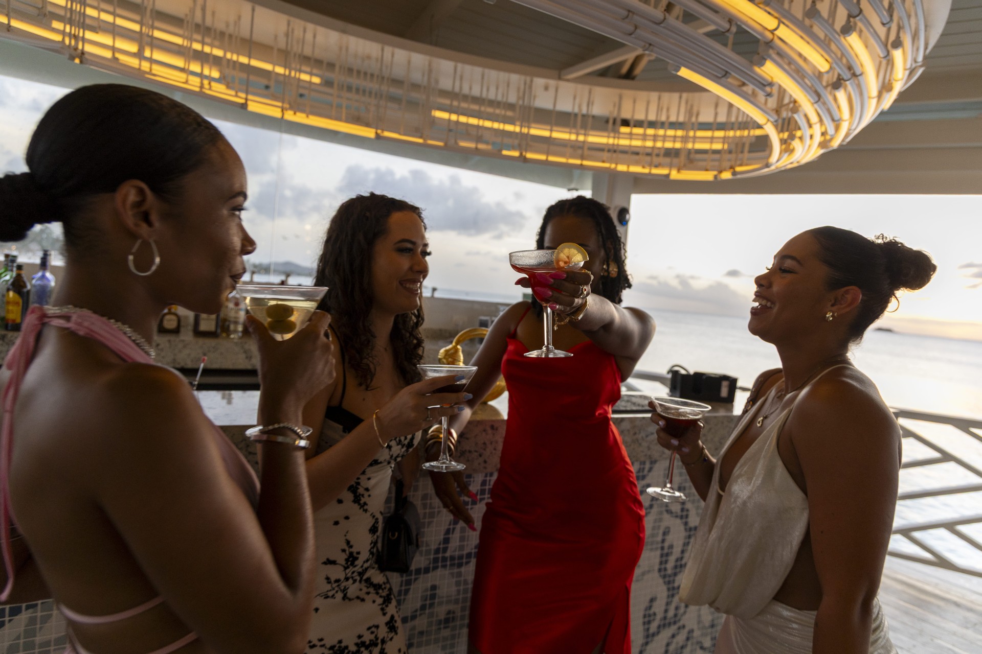 a group of women holding drinks