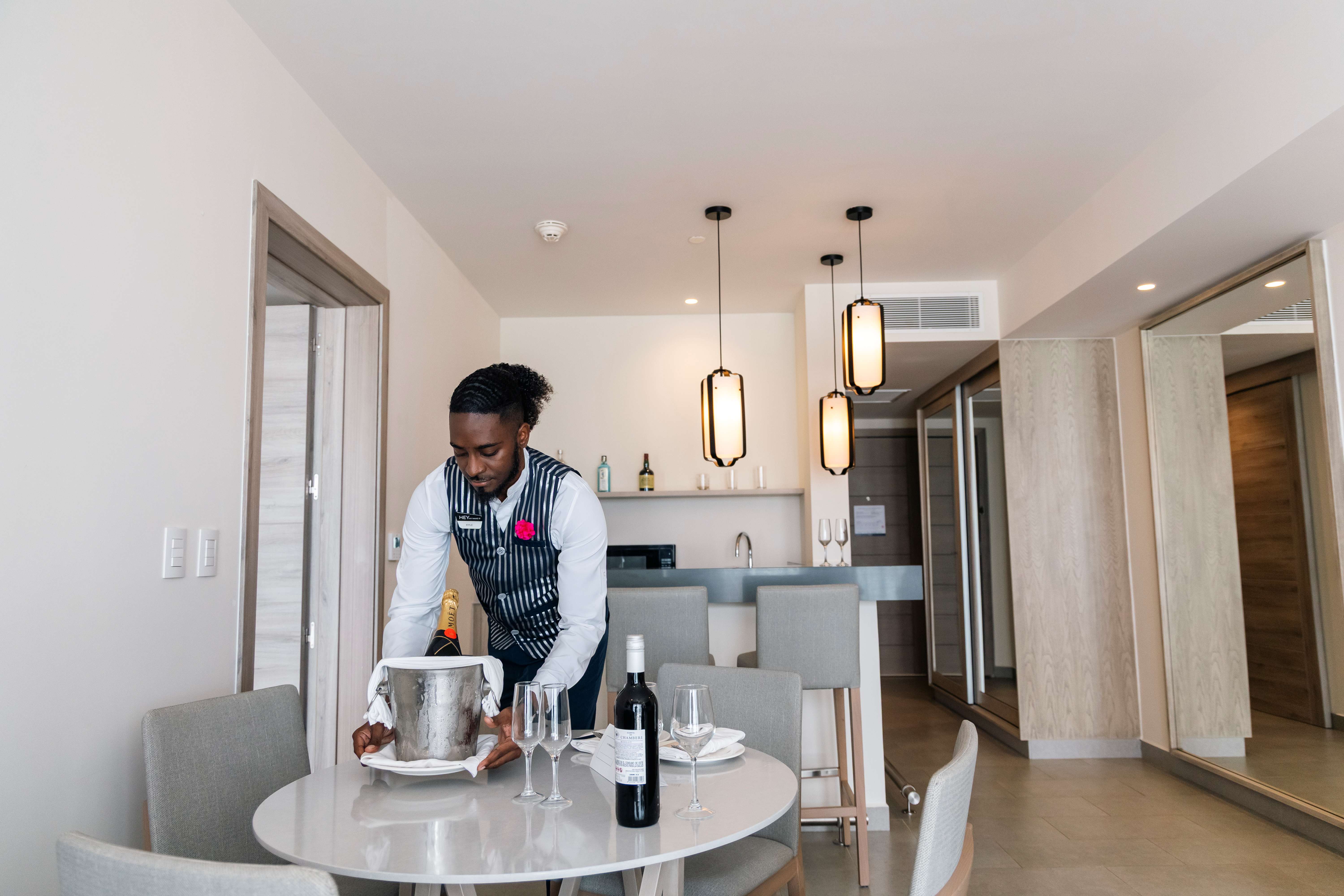 a man in an apron cutting a cake