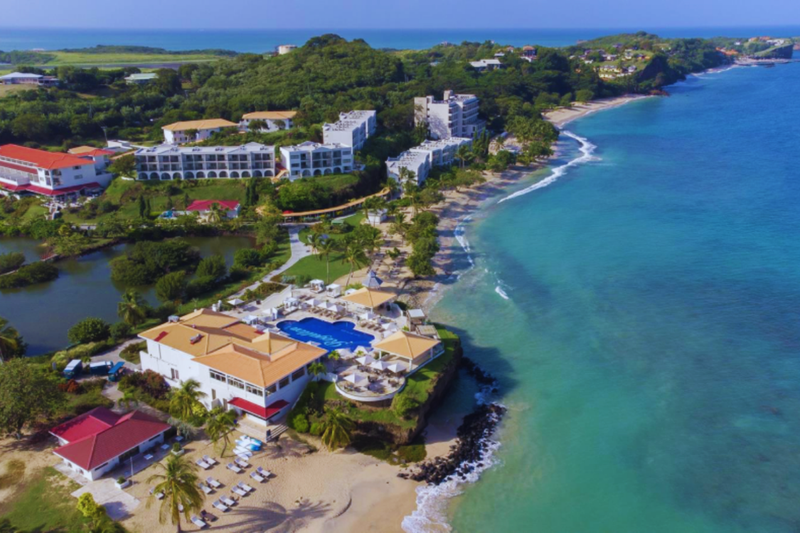 a beach with buildings and trees