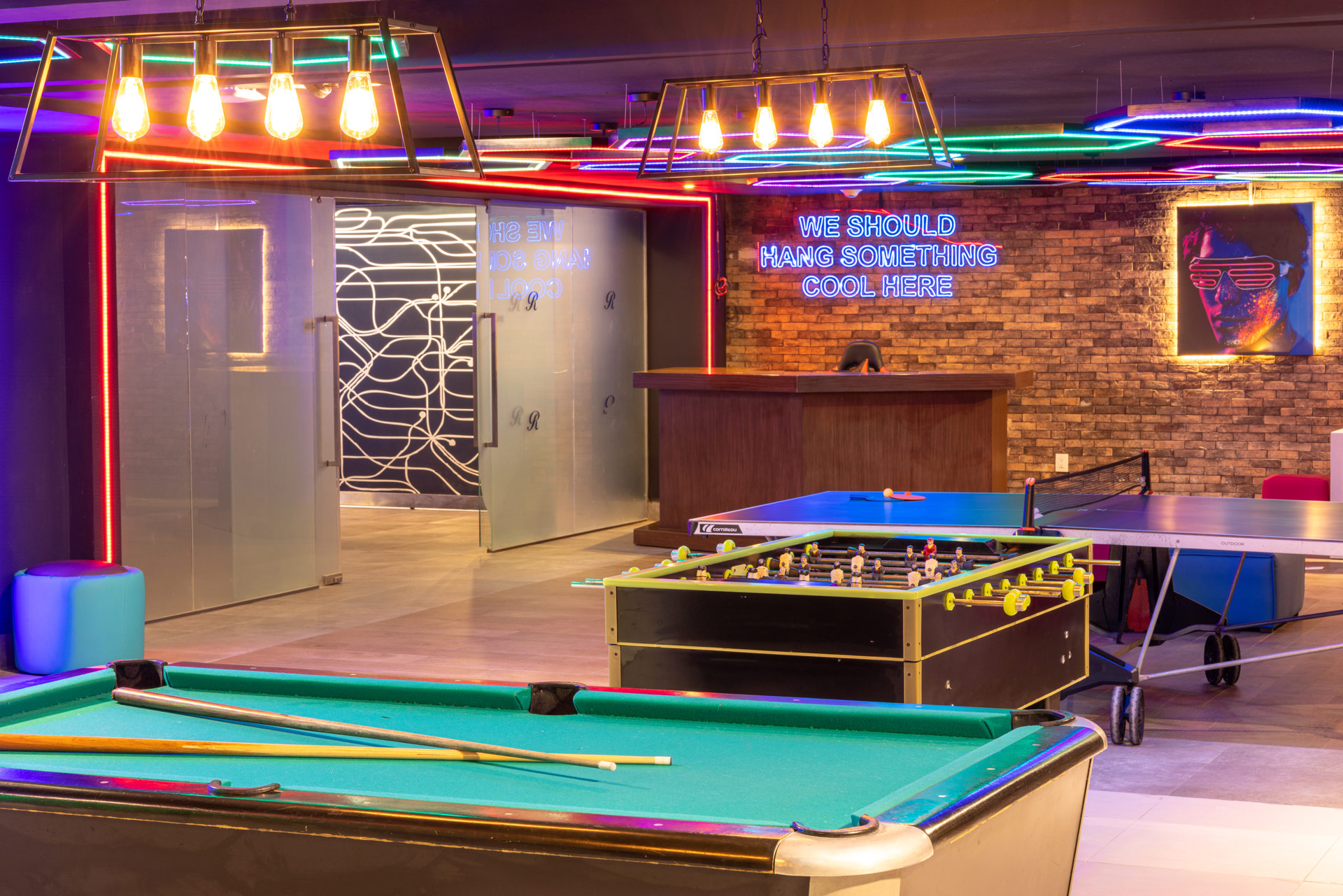 a pool table in a room with neon lights