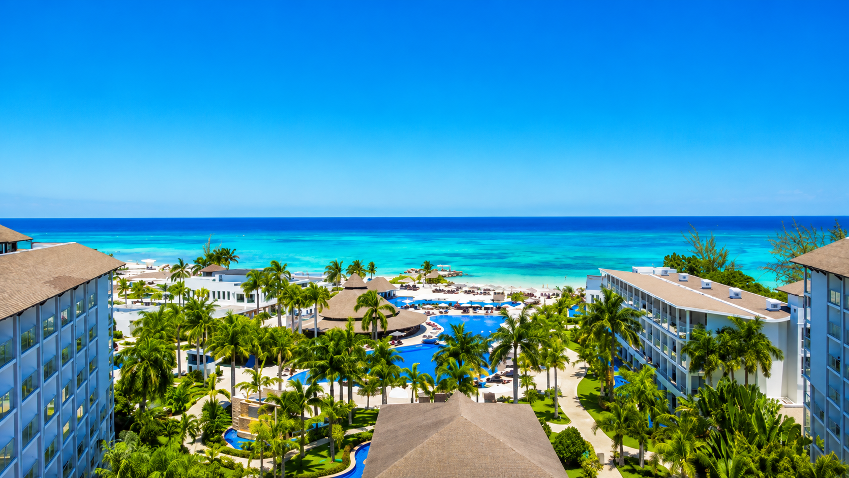a resort with a pool and palm trees