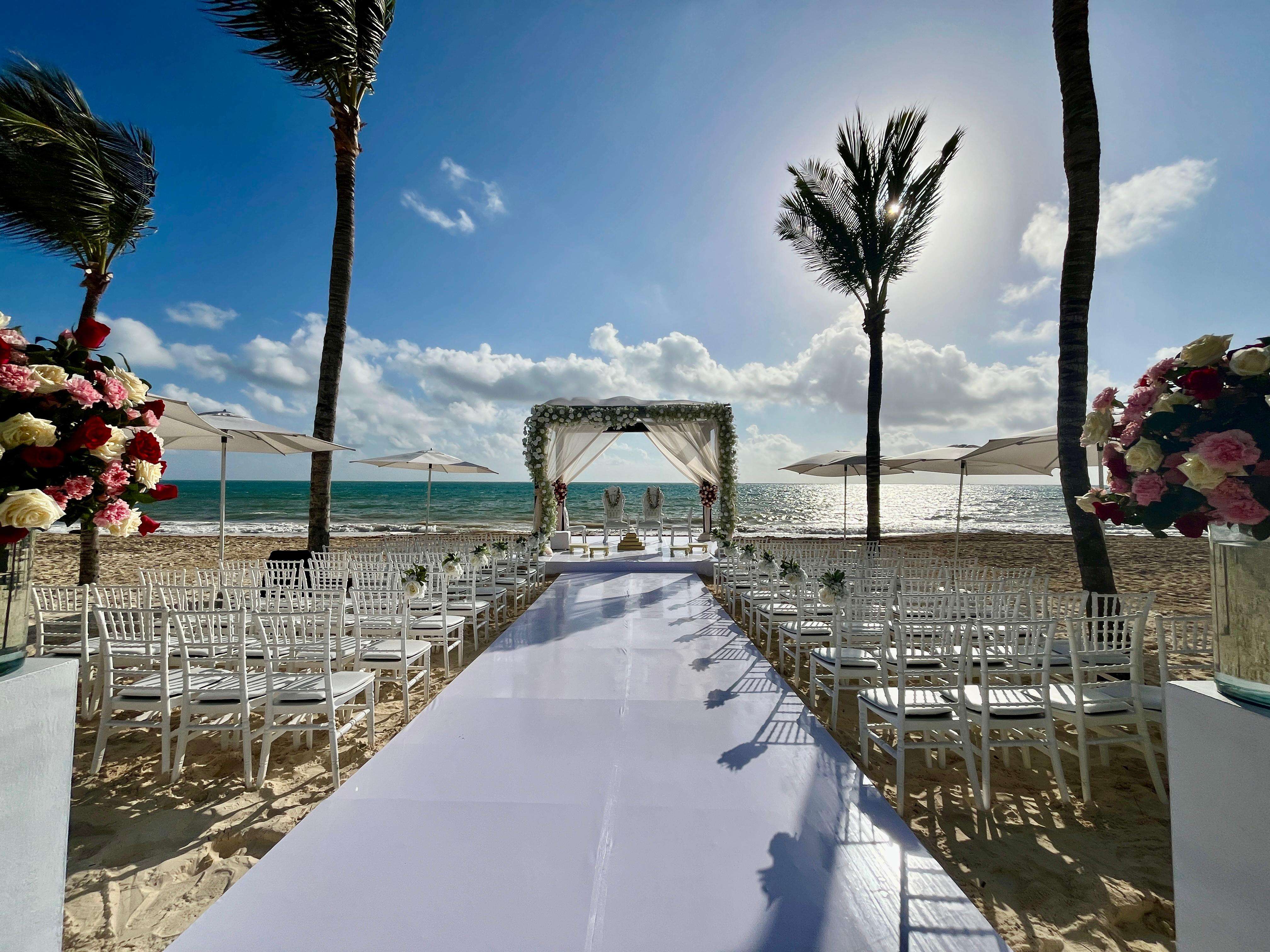 a beach with chairs and umbrellas