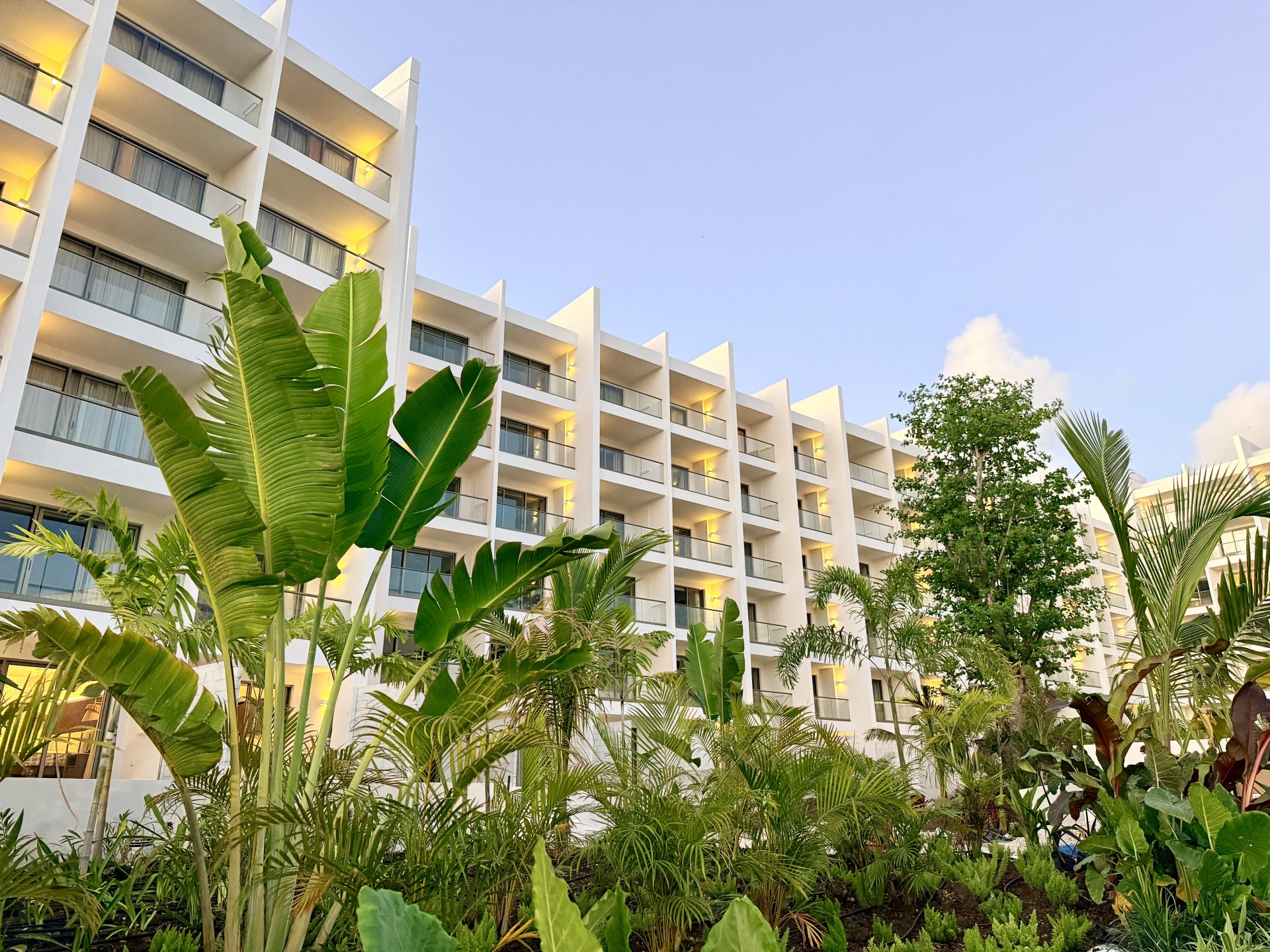 a building with many balconies and plants