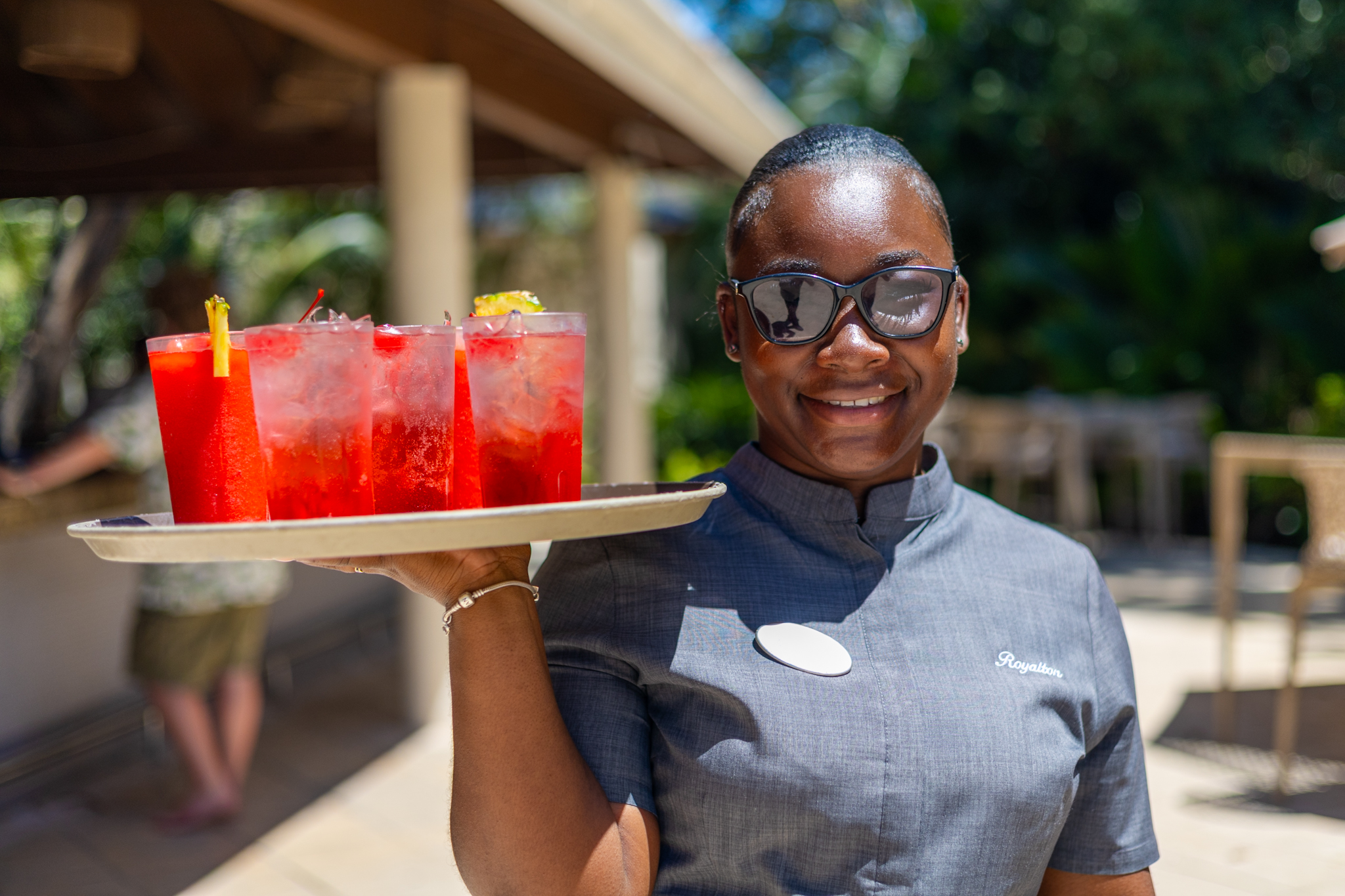 a woman holding a tray of drinks