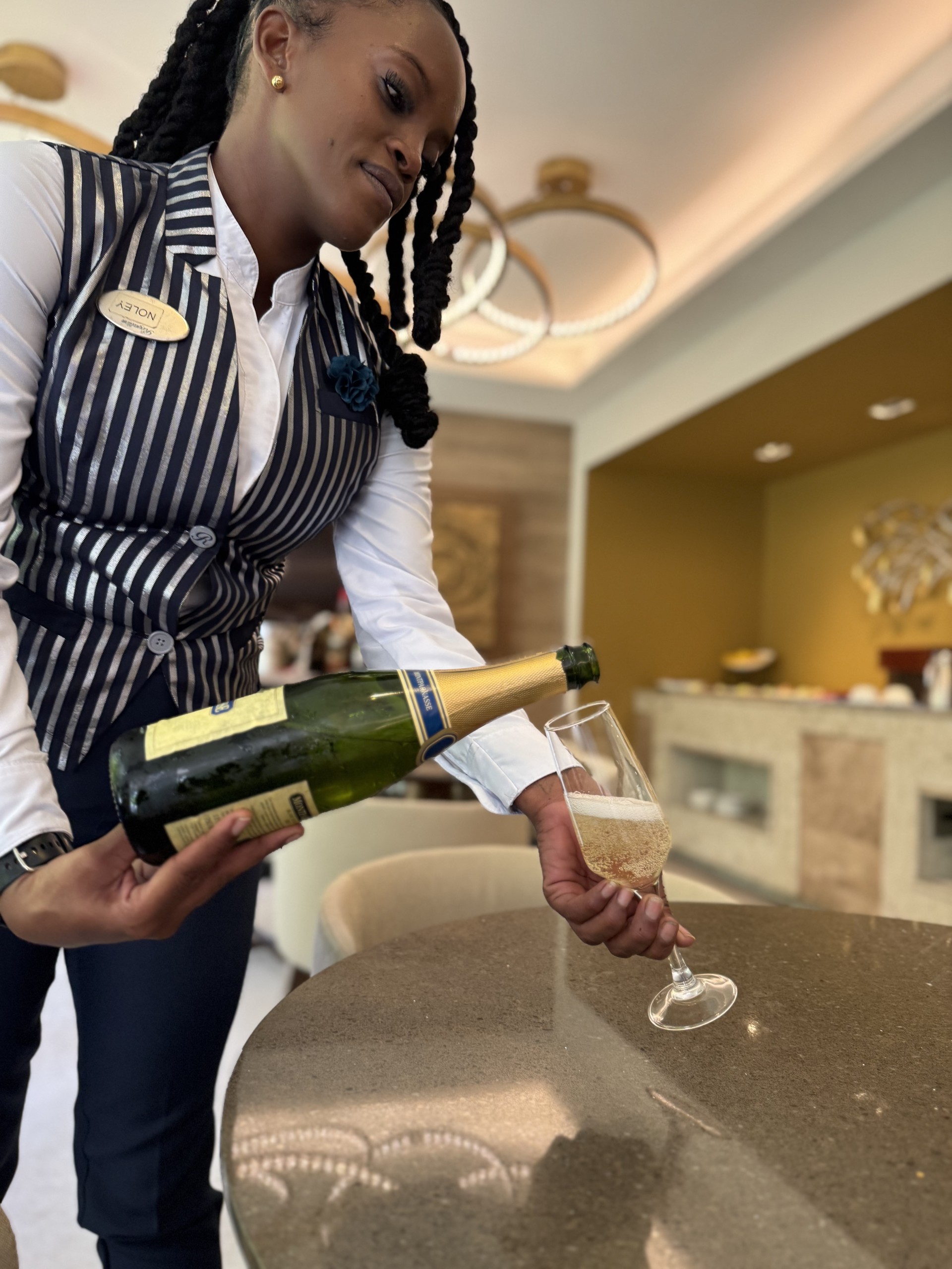 a woman pouring a glass of champagne