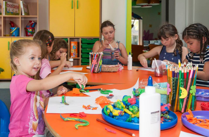 a group of children sitting at a table