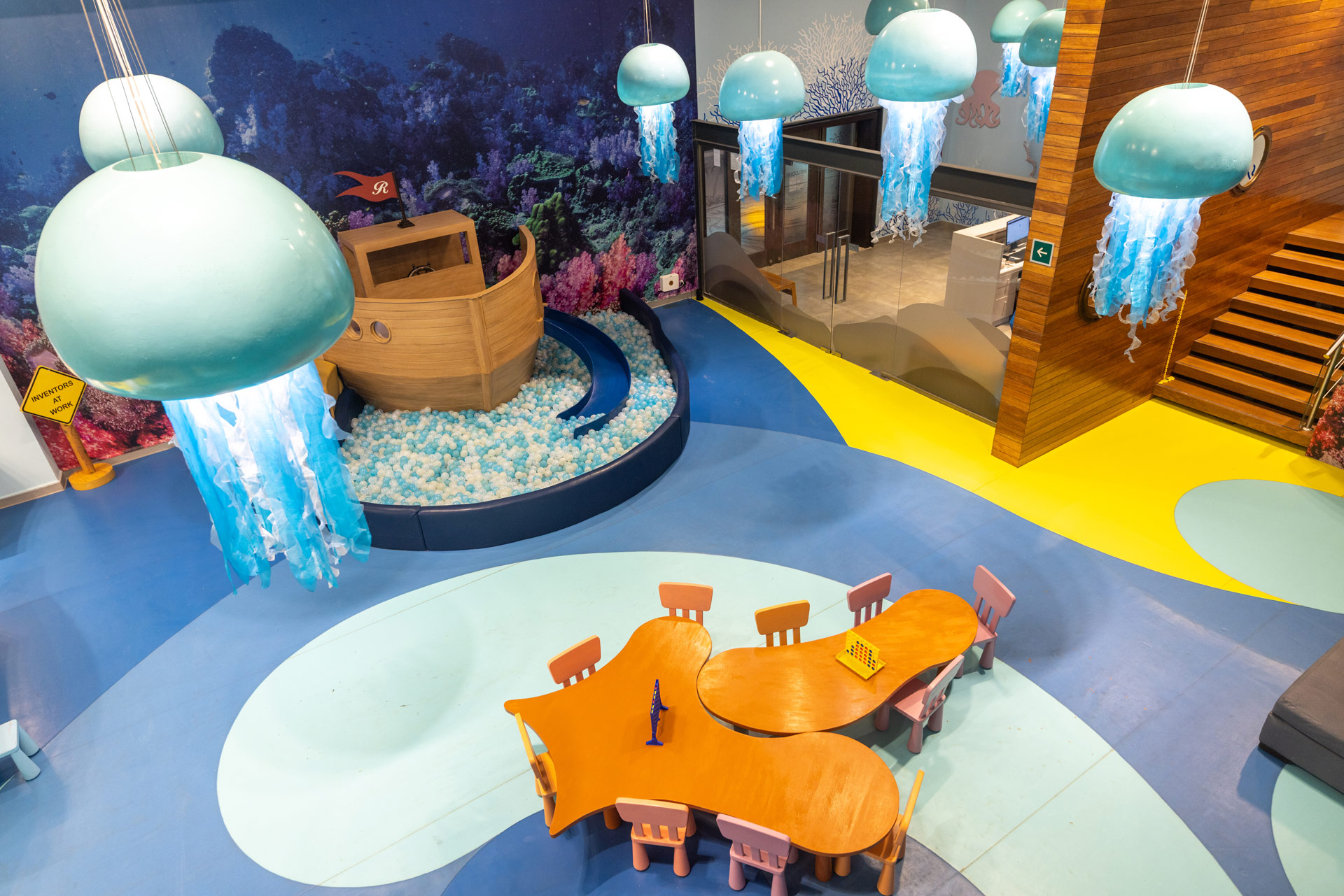 a room with a table and chairs and a toy boat