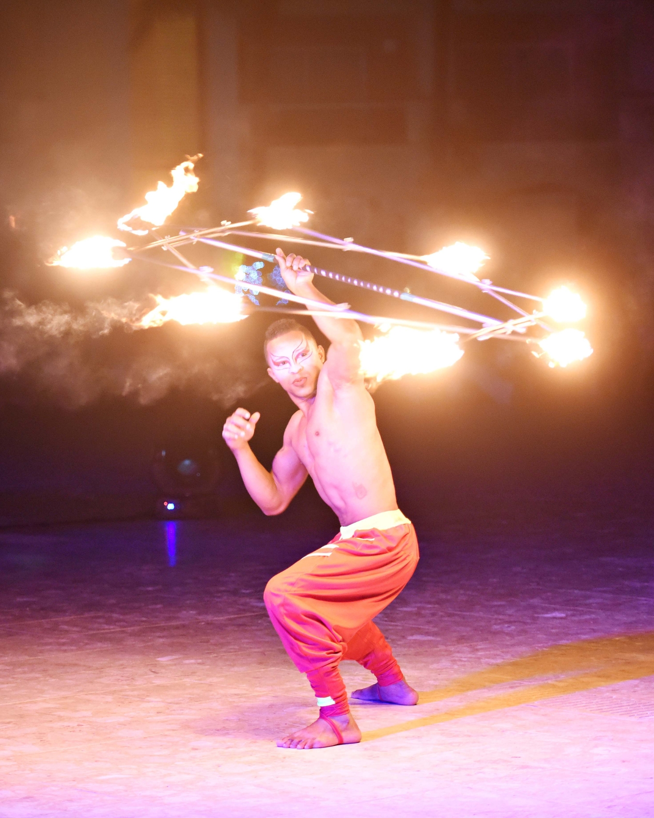a man holding a fire hoop
