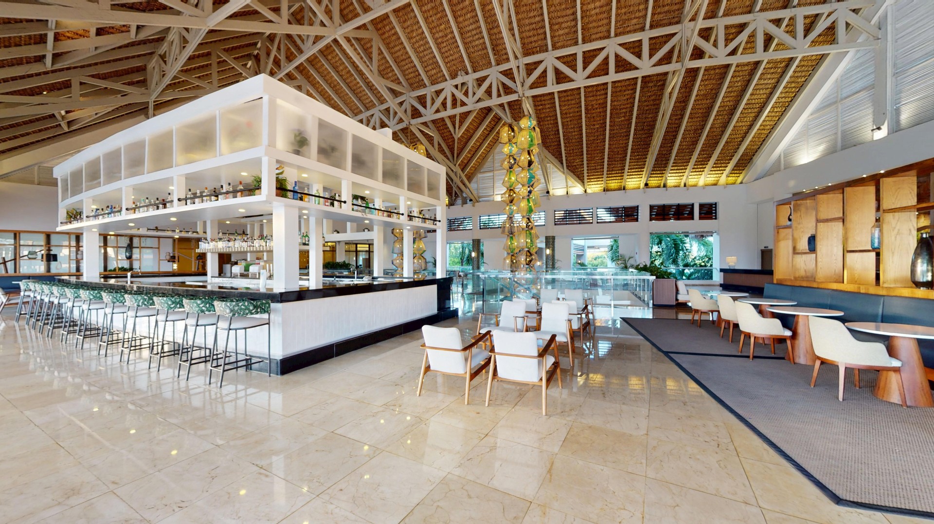 a large room with a bar and chairs