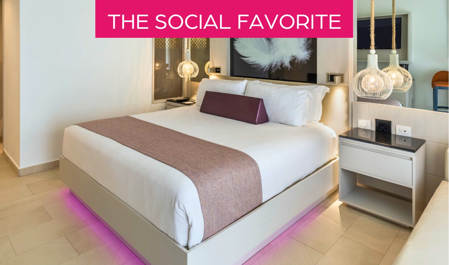 a bed with a purple blanket and a picture above it