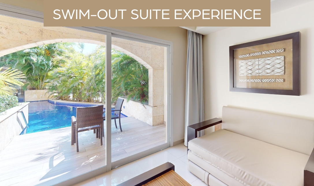 a room with a couch and a pool outside