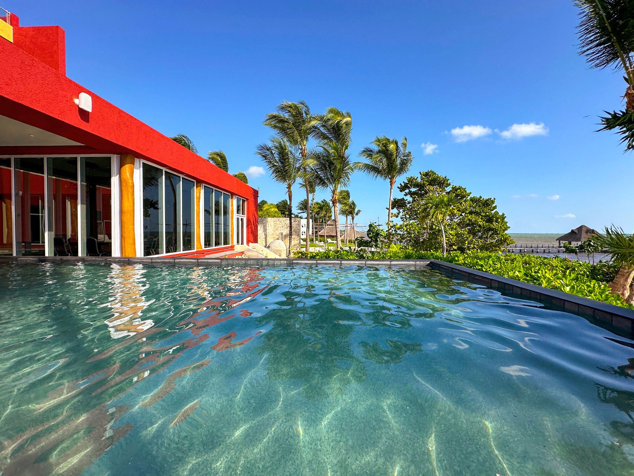 a pool with a building and trees in the background