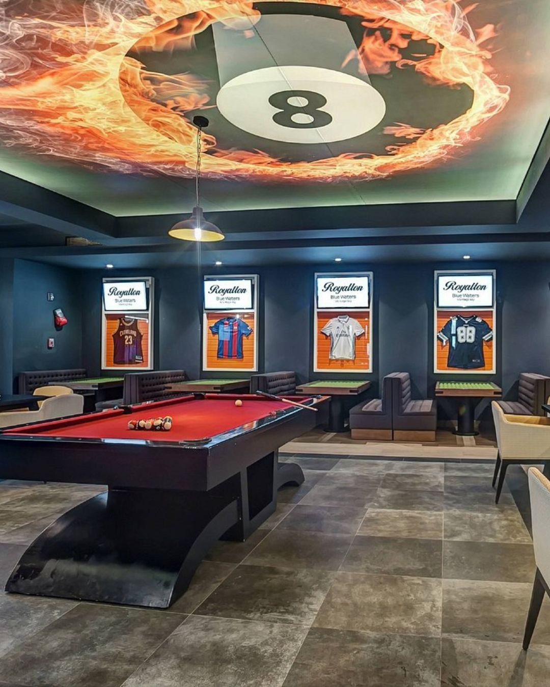 a pool table in a room with a picture on the ceiling