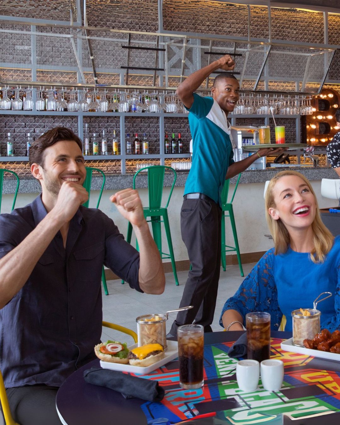 a group of people sitting at a table with food