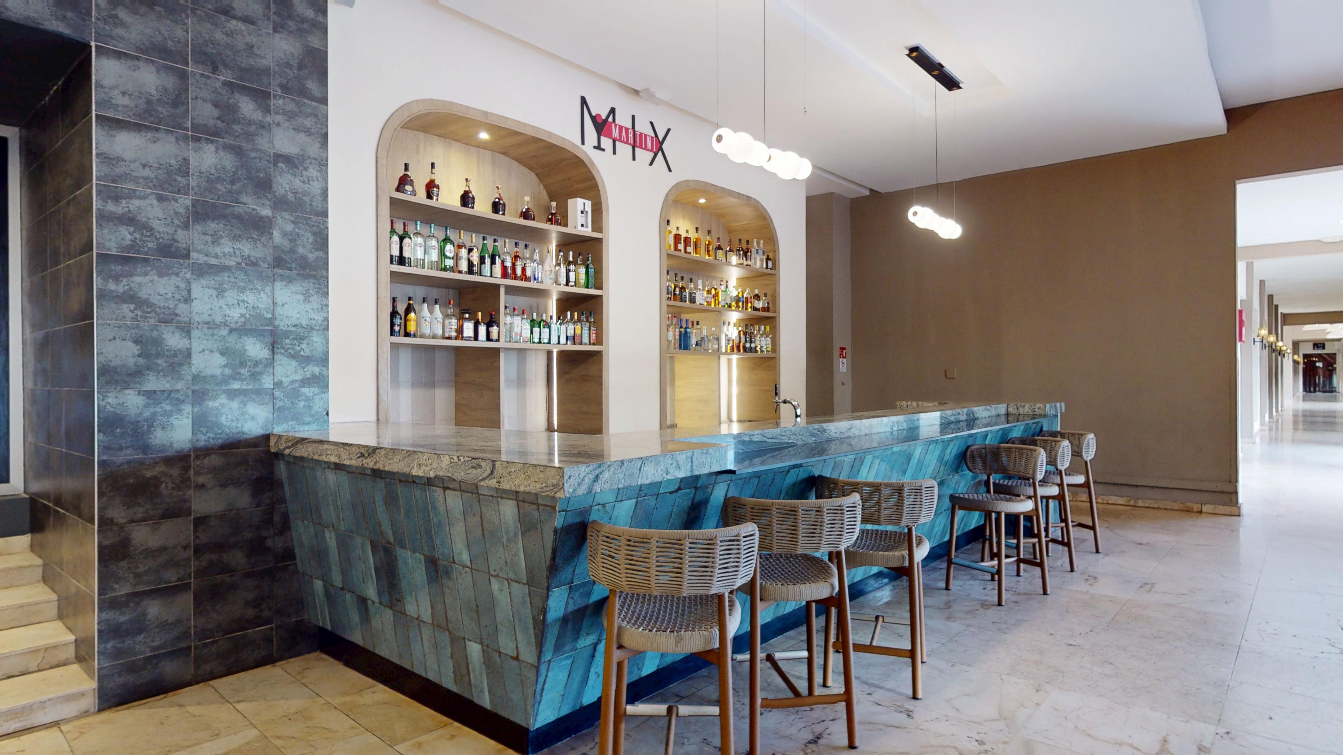 a bar with a counter and chairs