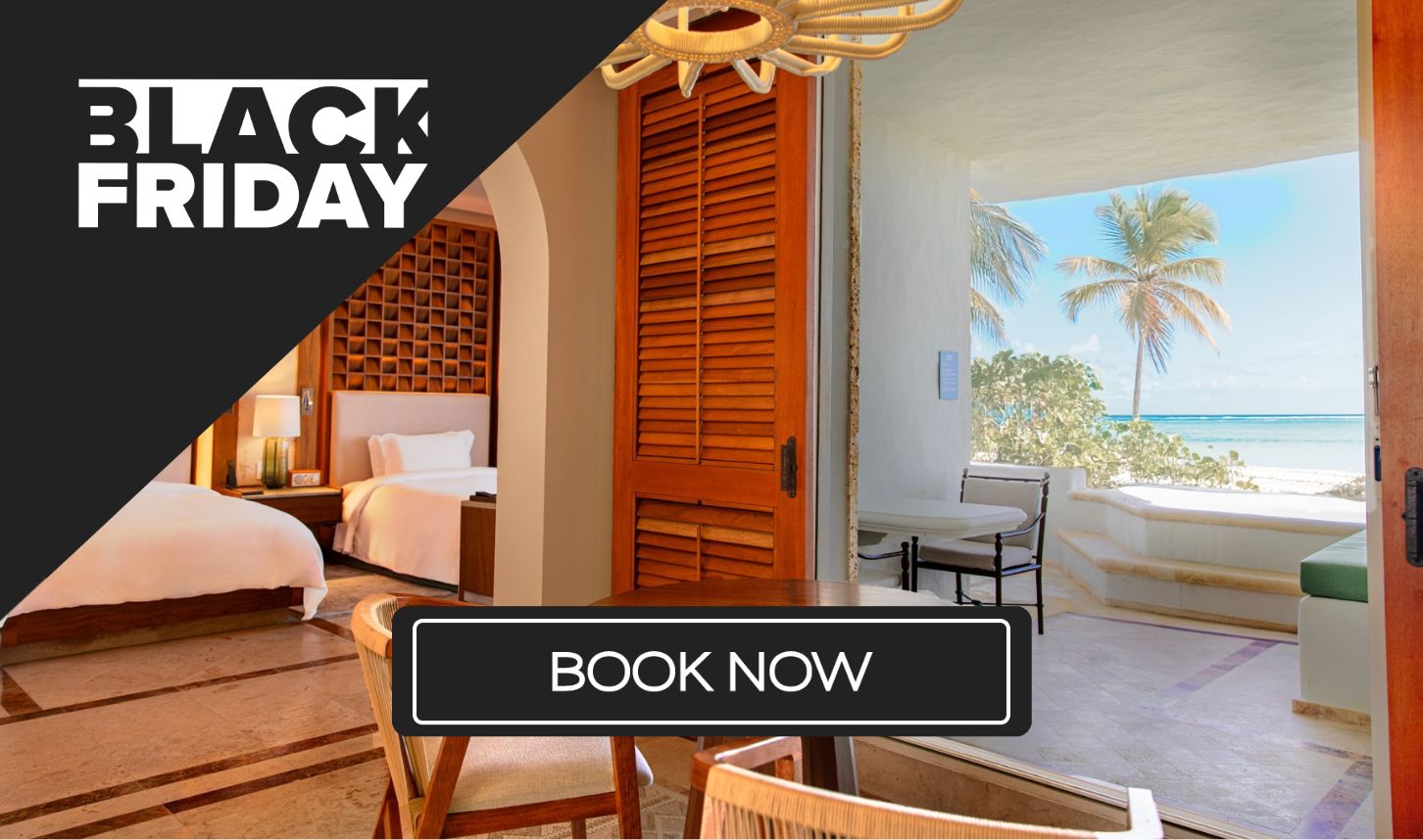 a room with a bed and chairs