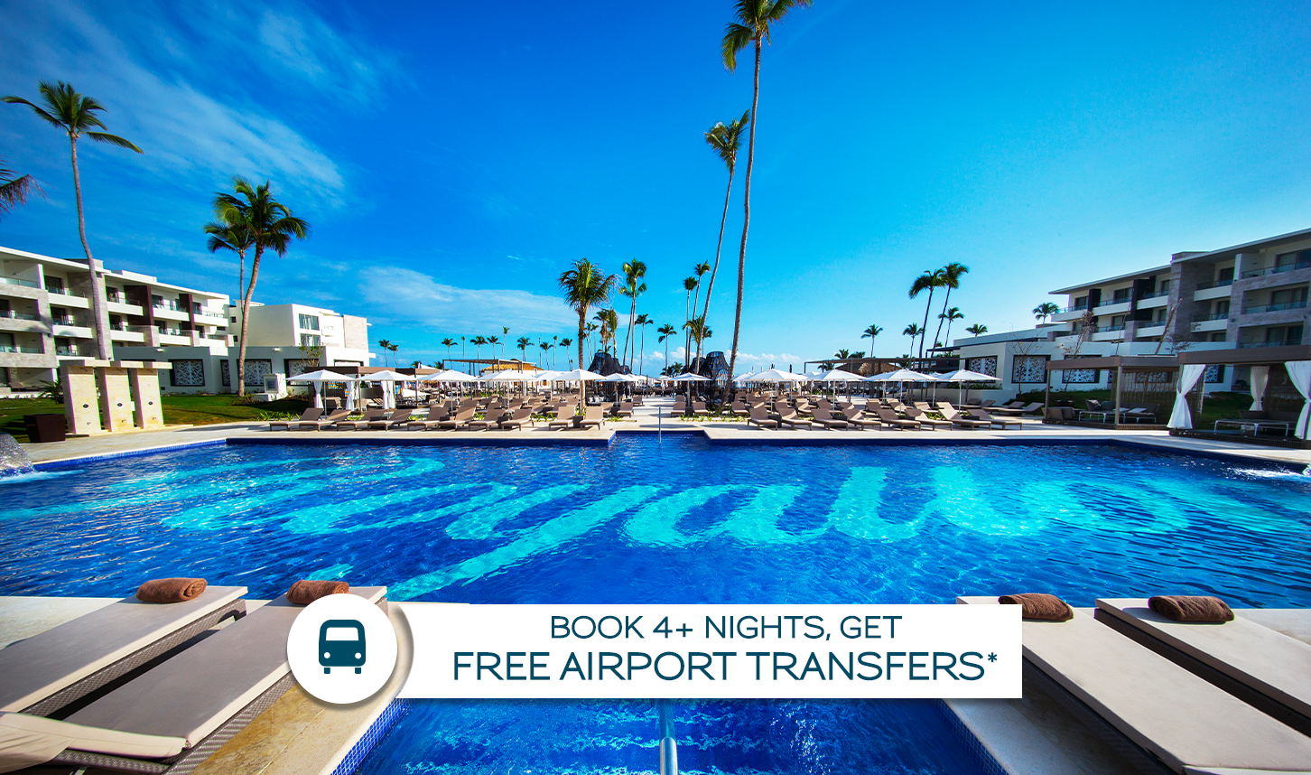 a pool with palm trees and a building