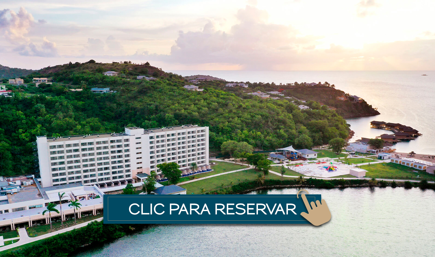 a large building on a hill next to a body of water