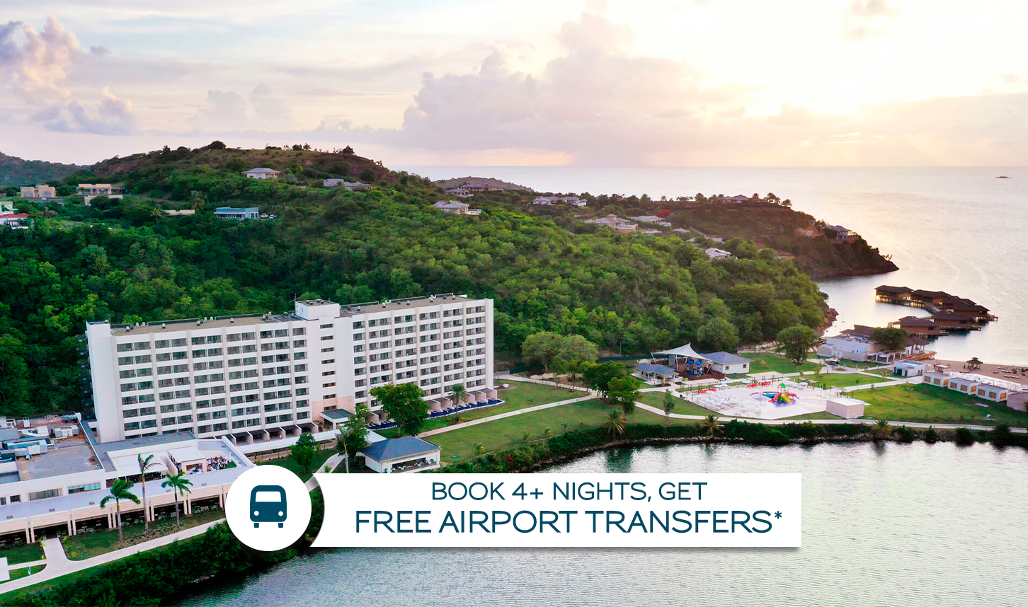 a hotel on a hill with trees and a playground