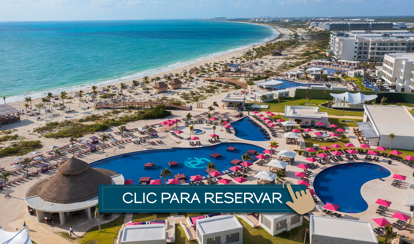 a beach with a swimming pool and a large body of water