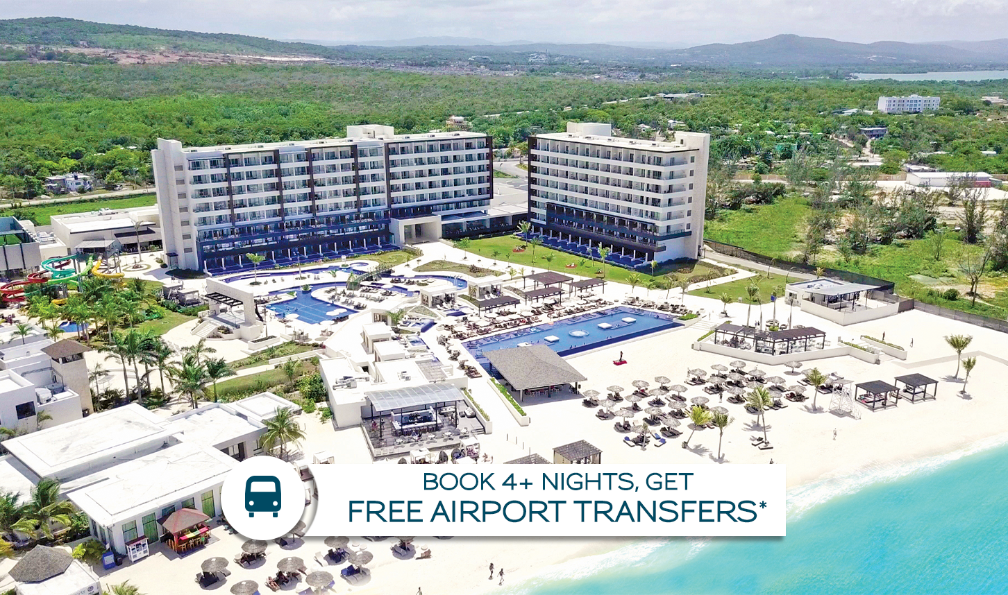 a group of buildings with a swimming pool and a beach