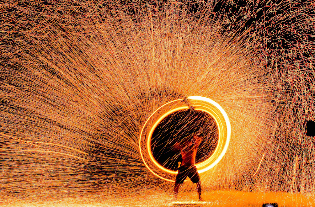 a man holding a circle of fire