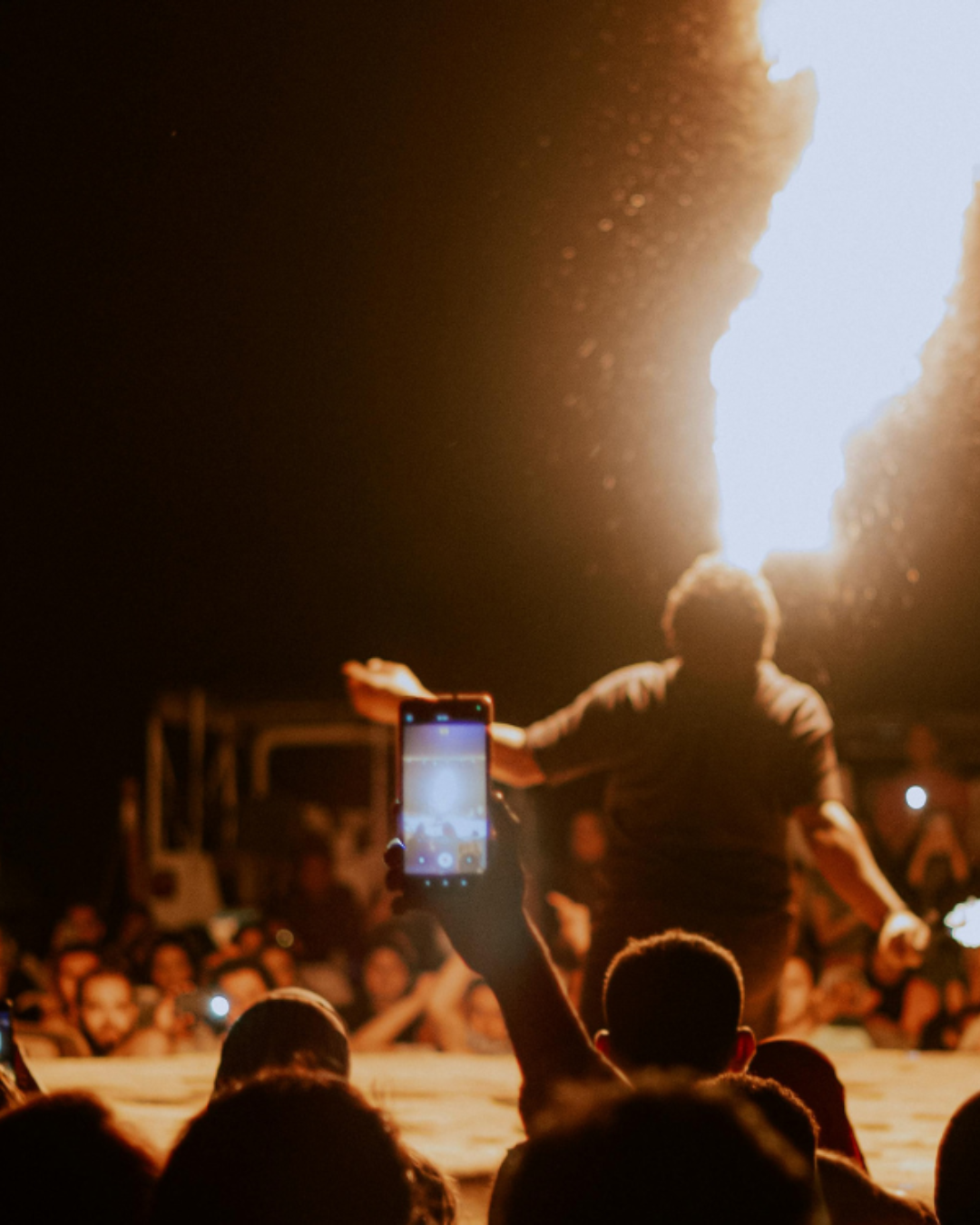 a person holding a phone up to a crowd of people