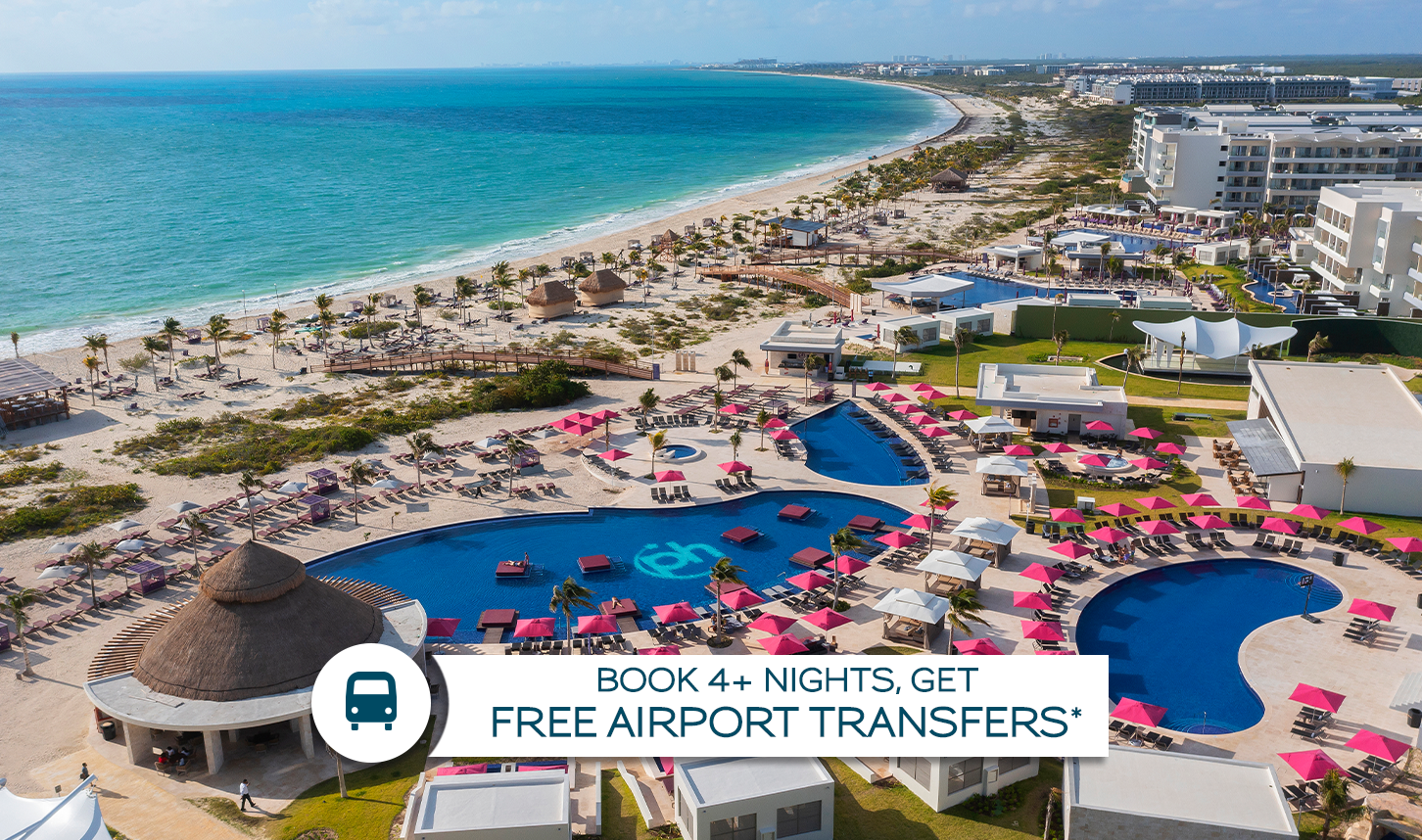 an aerial view of a beach with a swimming pool and a large body of water