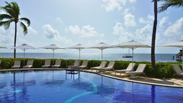 a pool with chairs and umbrellas