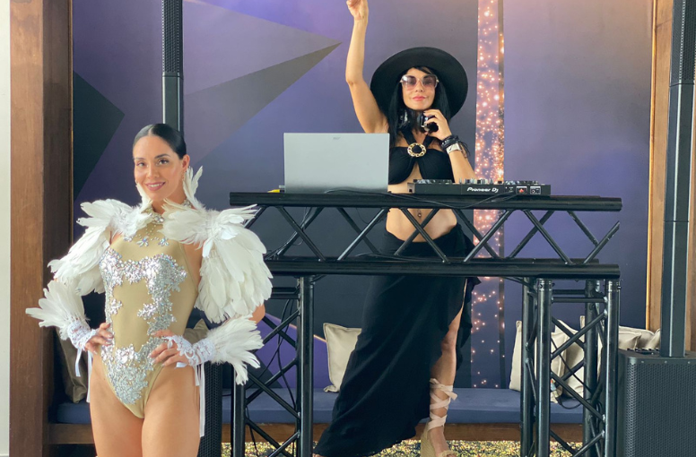 two women in clothing at a dj booth