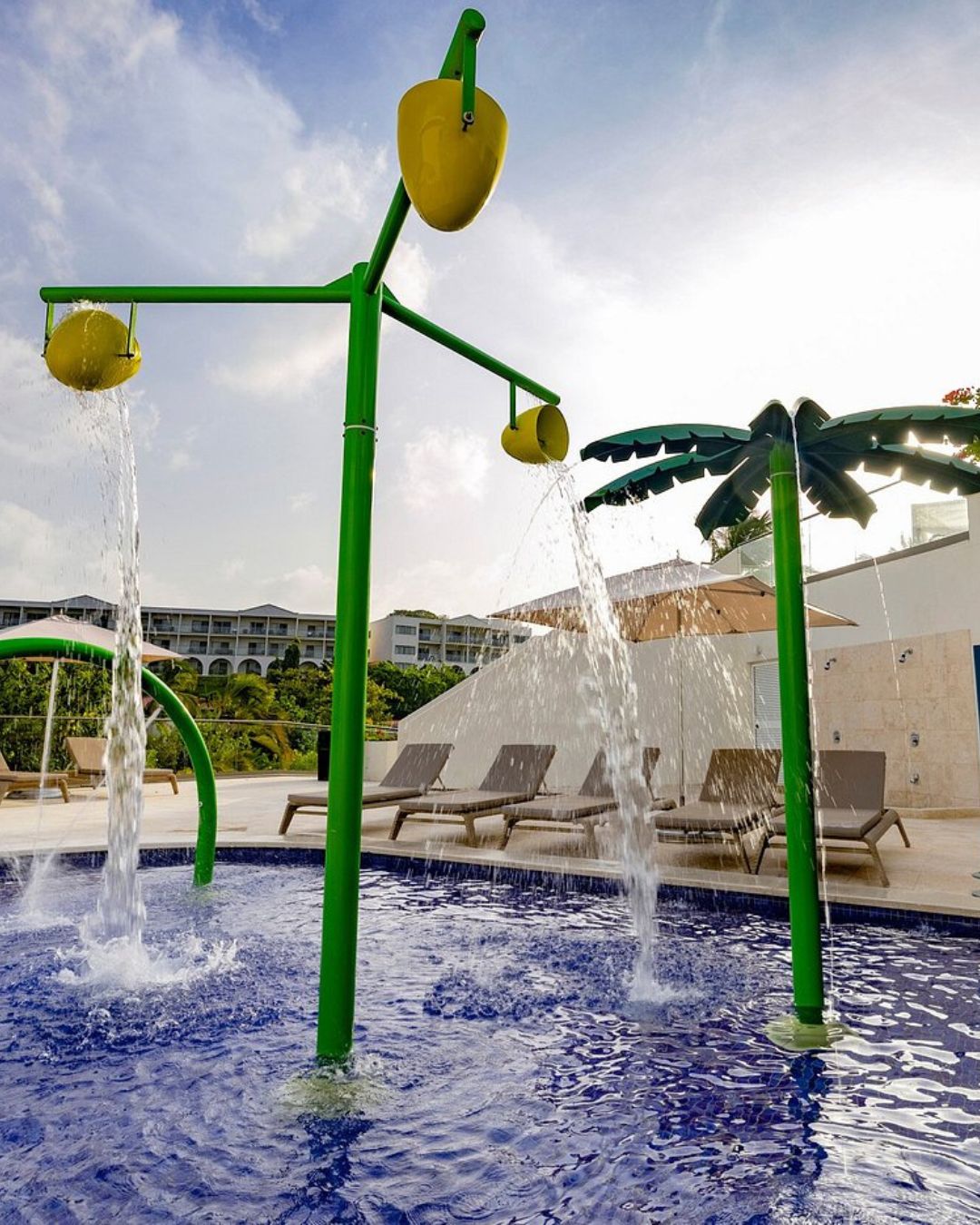 a water park with a palm tree and a pool