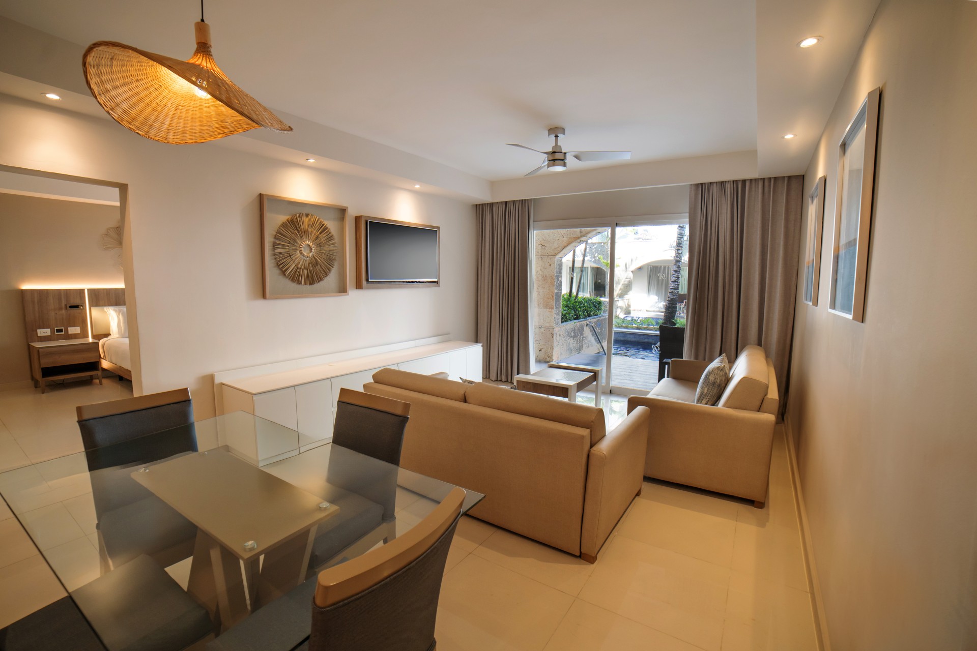 a living room with a glass table and couches