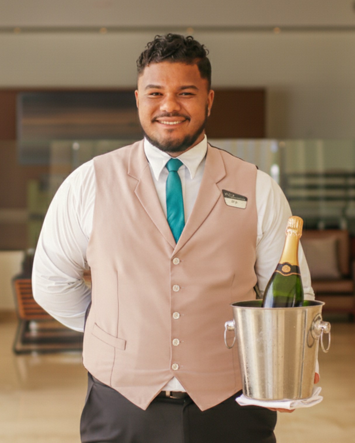 a man holding a champagne bottle in a bucket