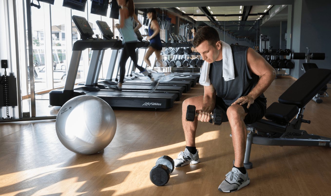 a man lifting weights in a gym