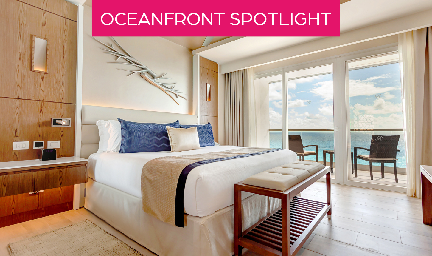 a bed with a bench and a window overlooking the ocean