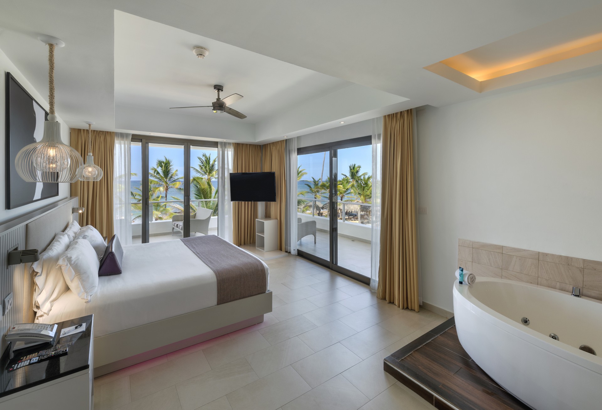 a bedroom with a bathtub and a window