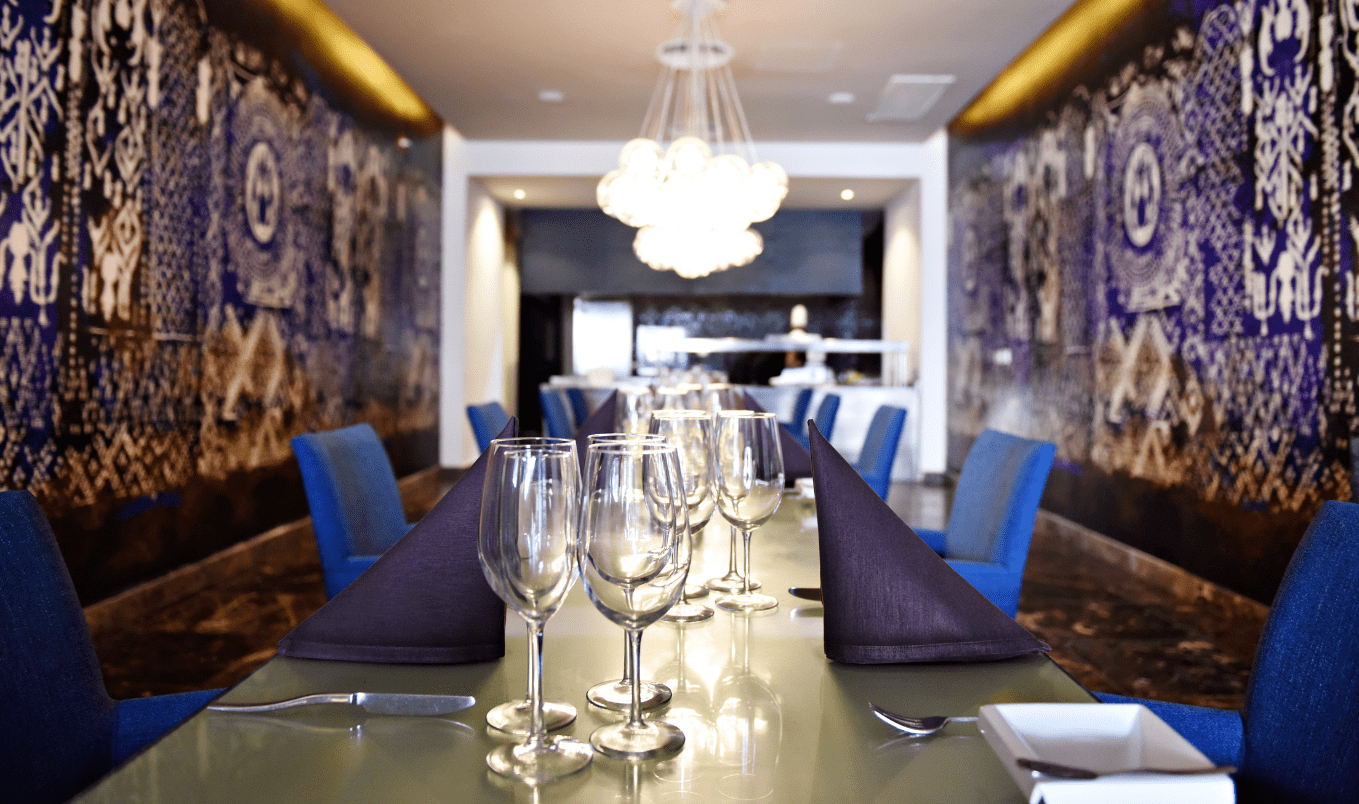 a table with wine glasses and napkins