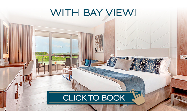 a hotel room with a large bed and a glass door