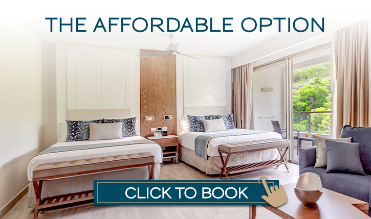 a room with two beds and a fan