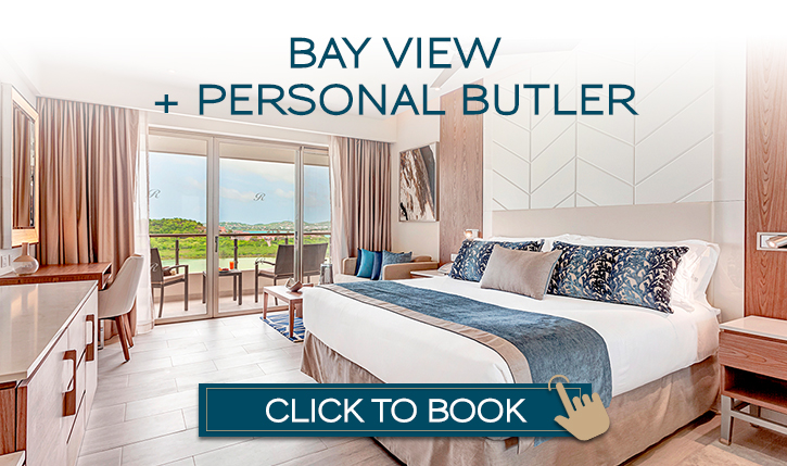 a hotel room with a large bed and a glass door