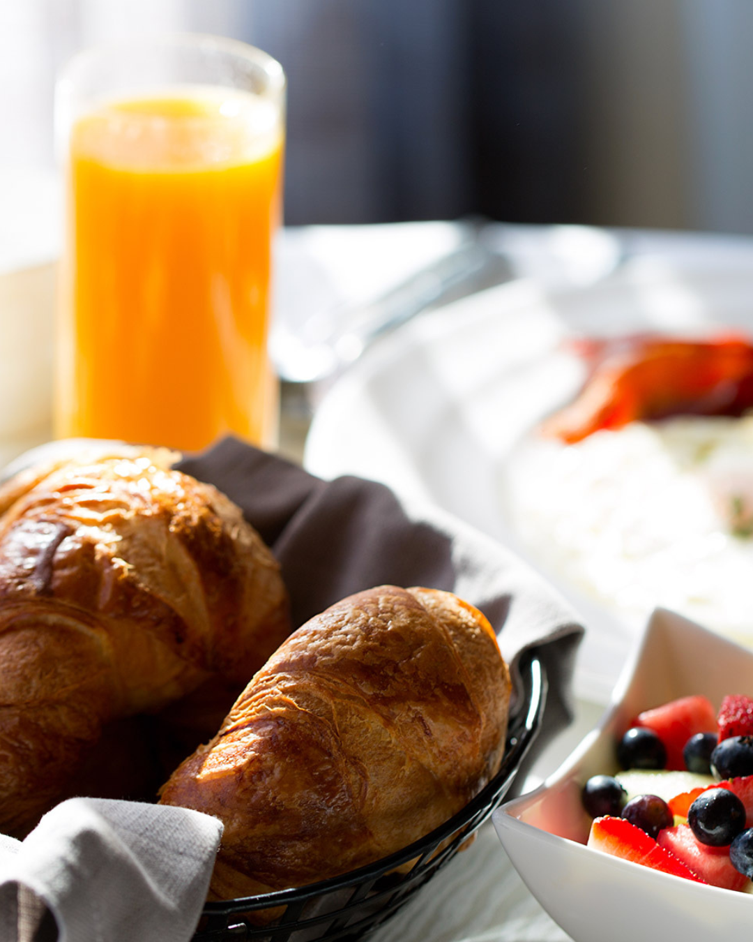 a plate of food and a glass of orange juice