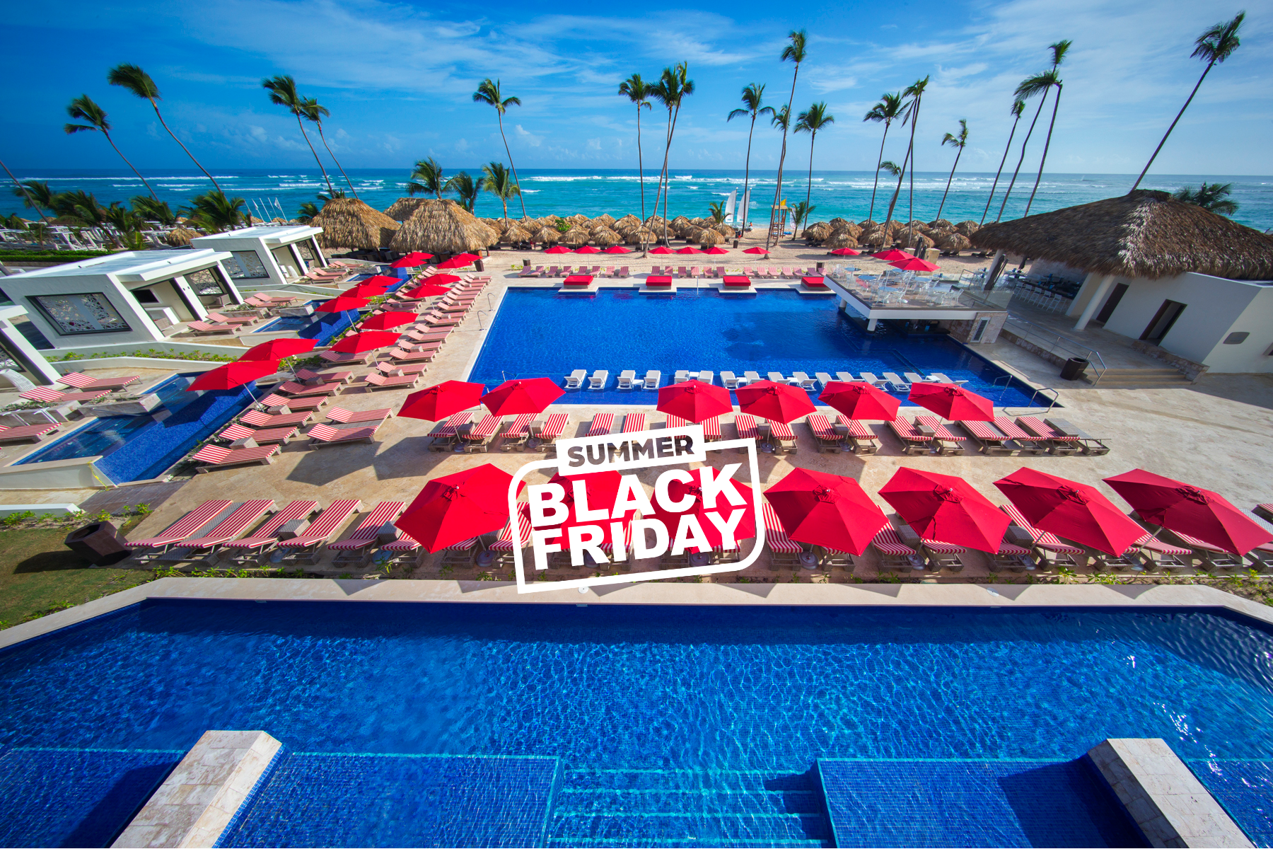 a pool with umbrellas and chairs and palm trees
