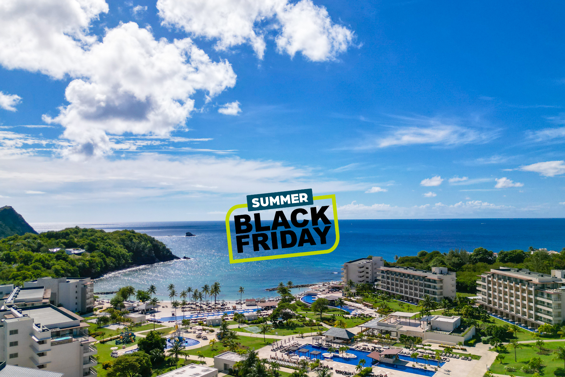 a beach with buildings and trees and a body of water