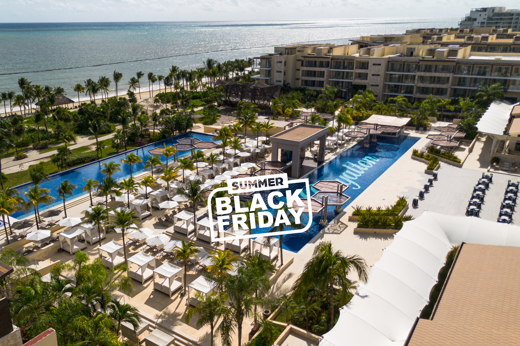 a resort with palm trees and a pool