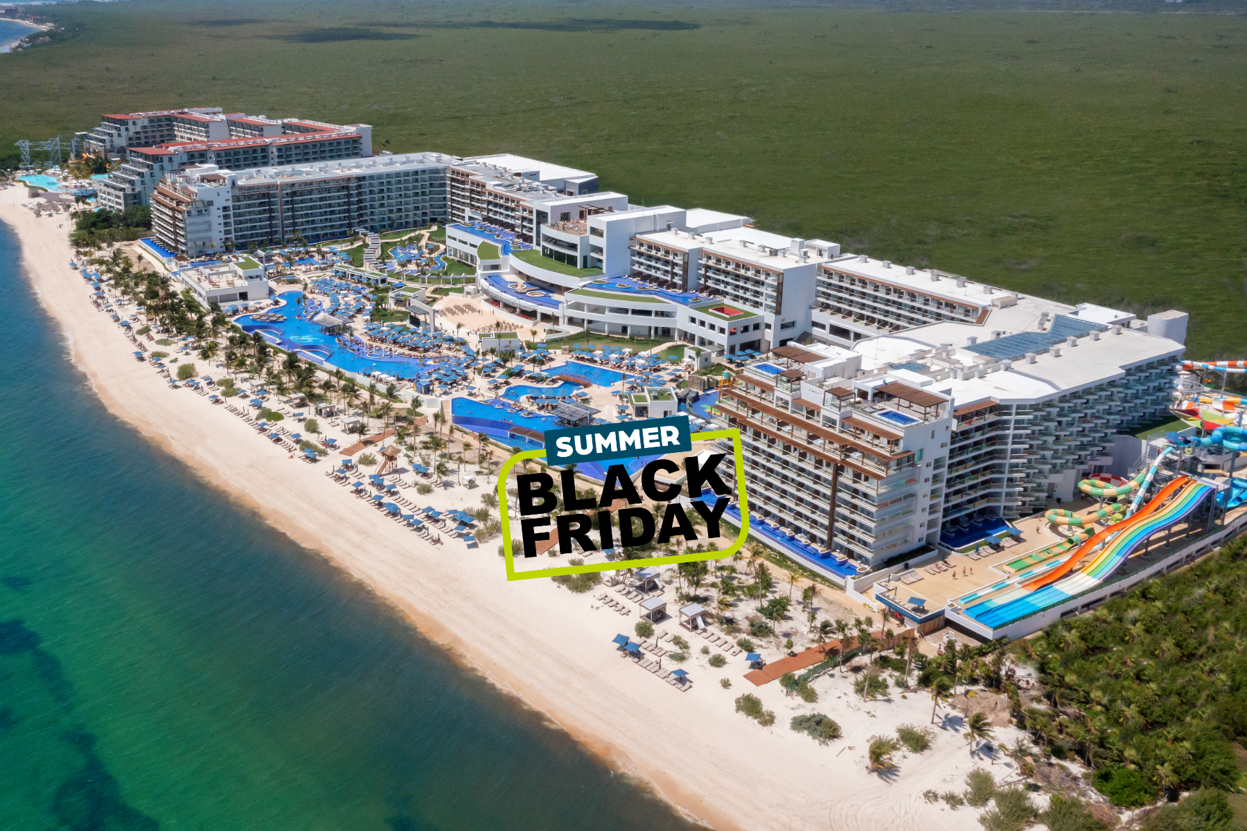 a large building with a pool and a beach