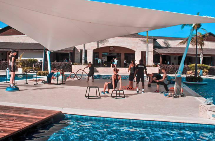 a group of people working out near a pool