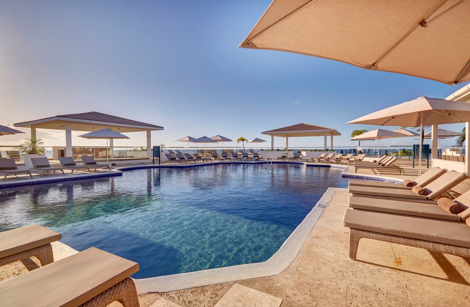 a pool with chairs and umbrellas
