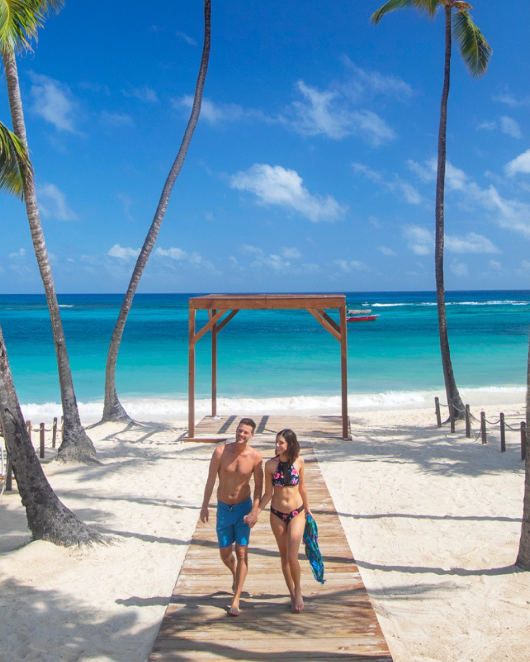 a man and woman walking on a beach